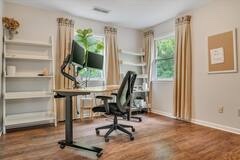Dedicated home office with an adjustable desk and ergonomic chair