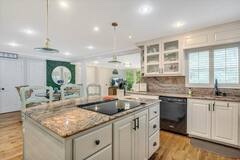 Spacious kitchen with granite counters and abundant cabinetry